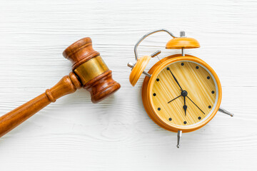 Alarm clock judges gavel, top view. Deadline and time management concept