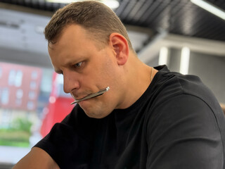 A car wrapping specialist applies a polyurethane film to the car. Detailer smoothes PPF. Car...