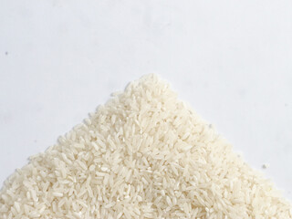 top view of isolated white background rice grains arranged in a triangle shape