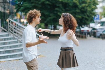 Young Couple Arguing Loudly in Public Urban Street Scene