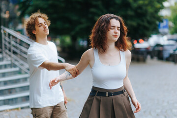 Man argues with upset girlfriend trying to explain himself on the street