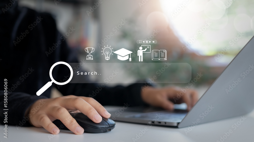 Poster hand using a mouse with a laptop and education-related icons on the search bar. concept of e-learnin
