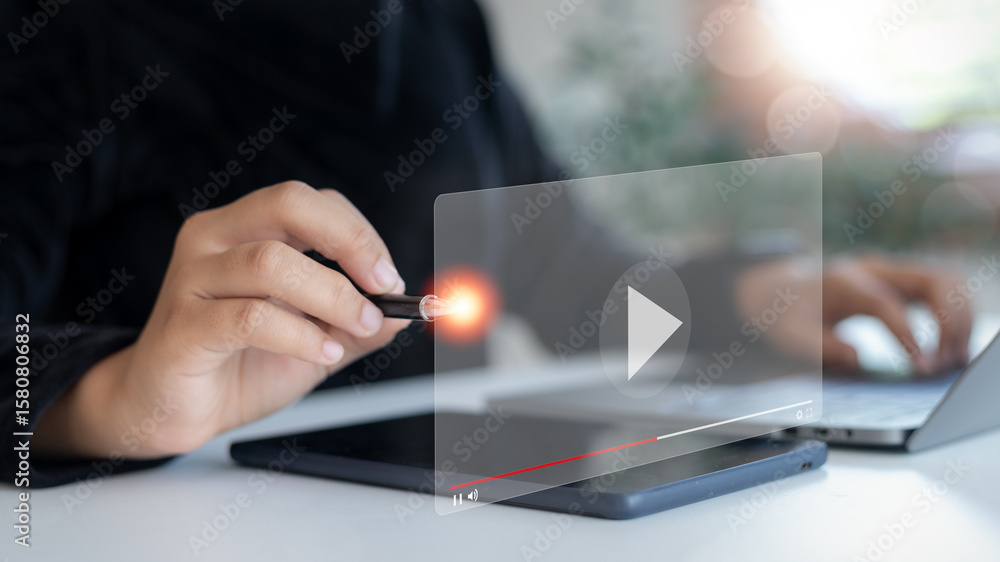 Poster close-up of a hand using a pen with a virtual video player screen overlay. concept of online video l