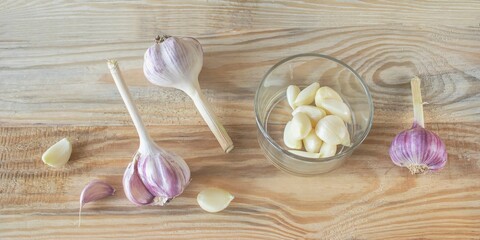 Garlic and head of garlic on wooden background. Organic farm garlic. Healthy food concept.