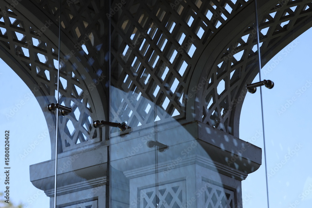 Poster a close-up shot of a clock reflection in a glass window, with a simple and clean composition