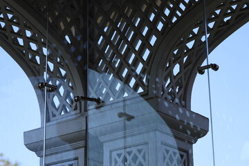 A close-up shot of a clock reflection in a glass window, with a simple and clean composition