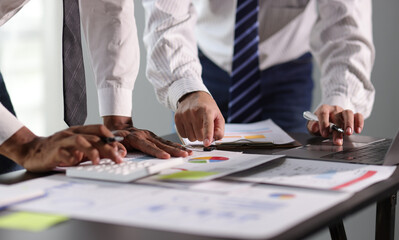 Businessman and financial advisor analyzing financial charts and graphs on document during meeting....
