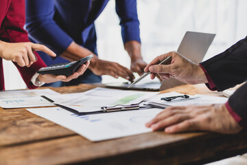Business people working together, analyzing financial documents. Financial advisor and auditor are...