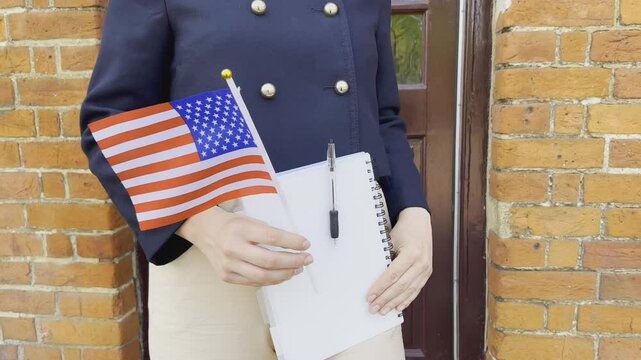 Woman with USA flag and notebook, concept of immigration, study, and dreams