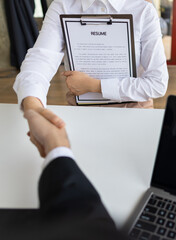 Job interview, unemployed woman submits job application and interviews. Manager read resumes and chat with new employees in the office.