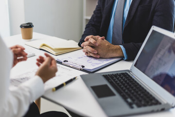 Employer interviewing job applicant and discussing resume details.