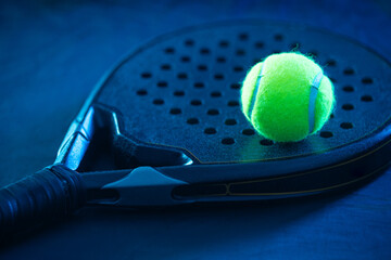 Padel racket and ball on court background ideal for tournament banners and promotional sports event design with space for text and logos