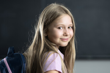 Portrait of elementary student smiling in classroom