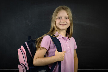 Portrait of a happy schoolgirl wearing backpack
