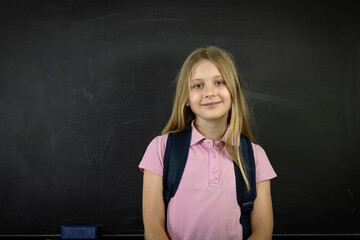 Portrait of a smiling schoolgirl with backpack
