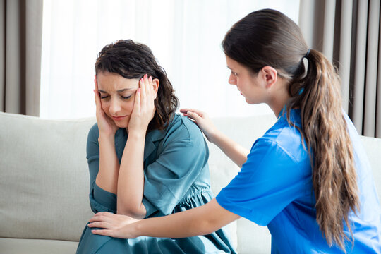Caregiver caucasian young nurse woman comforting patient woman with stress and concern, doctor encourage and consoling patient with cancer while worry and sadness, medical and insurance. - Powered by Adobe