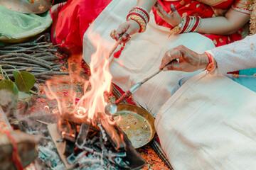 A Hindu wedding ceremony with a sacred fire, symbolizing purification and commitment, with the...