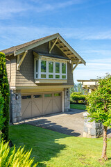 Garage door in luxury house with trees and nice landscape in Spring in Vancouver, Canada, North...