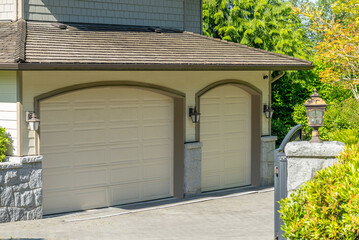 Garage door in luxury house with trees and nice landscape in Spring in Vancouver, Canada, North...