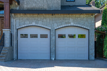 Garage door in luxury house with trees and nice landscape in Spring in Vancouver, Canada, North...