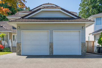 Garage door in luxury house with trees and nice landscape in Spring in Vancouver, Canada, North...