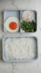egg and vegetables in lunch boxes with food ready to go for work or school, bento