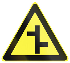 Warning road sign in China - Staggered crossroads