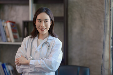 Portrait, medicine, and arms crossed with a woman doctor in the hospital for insurance or treatment—healthcare, happy or smiling, with a female medical professional standing alone in a clinic.