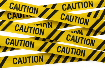 Tangled yellow caution tapes forming warning barrier, symbolizing hazard prevention and restricted zone boundaries