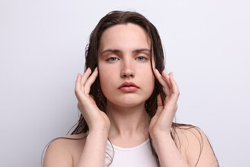 Fototapeta premium Portrait of beautiful woman with natural skin complexion on light grey background, closeup