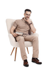Professional psychologist with notebook in armchair on white background