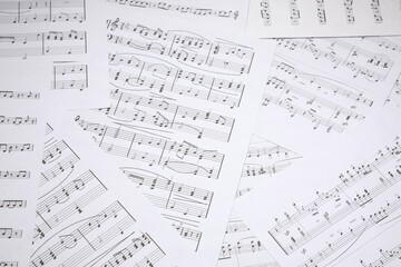 Sheets with musical notes as background, closeup