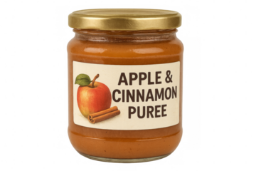 Glass jar of apple and cinnamon puree showing label on transparent background
