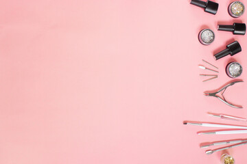 Manicure tools arranged on a soft pink background, perfect for nail salons, manicure courses, and...