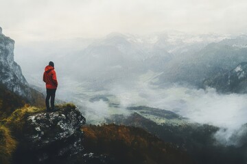 Obraz premium Lone hiker in red jacket on mountain cliff