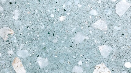 Close-up of light blue terrazzo texture with various sized chips.