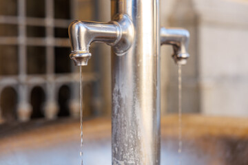 Close-up of dual spout stainless steel water fountain dripping