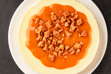 Cheesecake salted caramel sweet dessert fresh delicious gourmet food background on the table rustic food top view copy space
