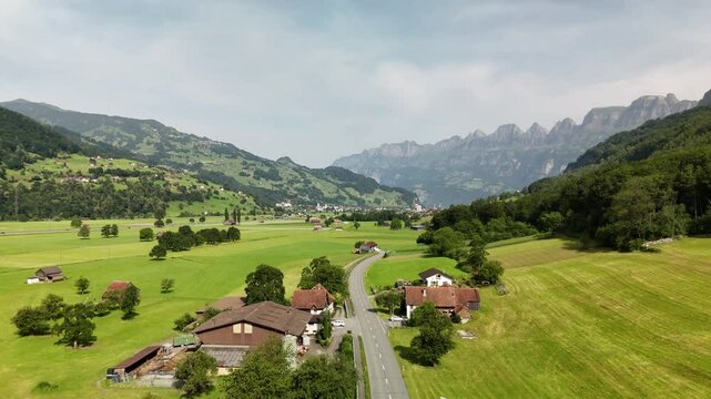 Scenic Aerial View of a Valley with Green Fields and Mountain Landscape in Switzerland near Flums, Berschis, and Walenstadt in the Canton of St. Gallen &ndash; Drone Footage
