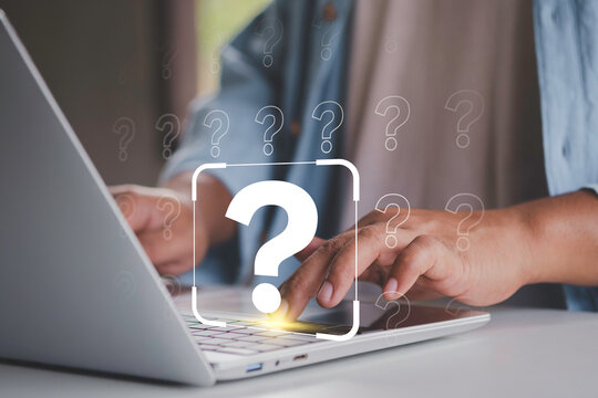 International ask a question day concept, man uses a laptop to search for information to solve doubts, ask questions and find answers. question mark, Answer, Q and A, Communication and Brainstorming