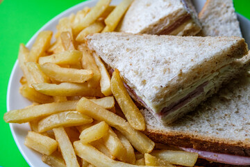 Homemade Ham and Cheese Sandwich In Sliced Brown Bread With Chips Or Fries