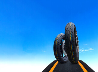 Motorcycle tires on asphalt road with blue sky background concept of speed, performance and travel