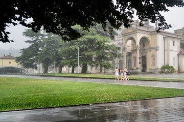 four young women walking in the rain
