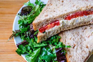 Freshly Made Egg and Tomato Sandwich With Salad Cream And Green Salad Leaves