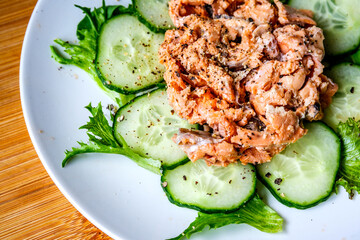Red Salmon Fish With Cucumber and Salad Leaves