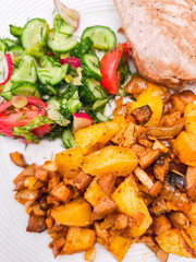 Delicious  tuna steak with roasted potatoes and fresh salad