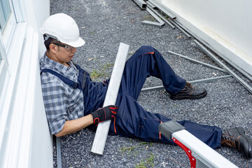Injury at work. Accident at construction site. Unconscious Asian male worker lying on the floor got...