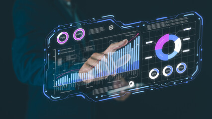 A futuristic transparent digital interface displaying charts, graphs, and data analytics with a hand interacting with it.
