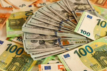 Detailed close-up of overlapping US dollar and euro banknotes in 100 and 50 denominations. Perfectly captures the essence of wealth, finance, the global economy, and international trade.