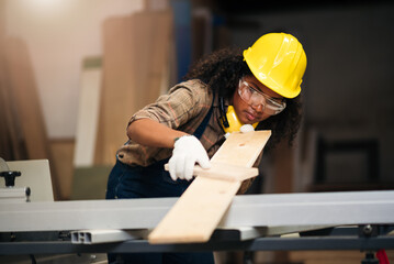Carpentry Woman Wearing Safety Equipment Crafting Wood in Factory, African American Worker in...